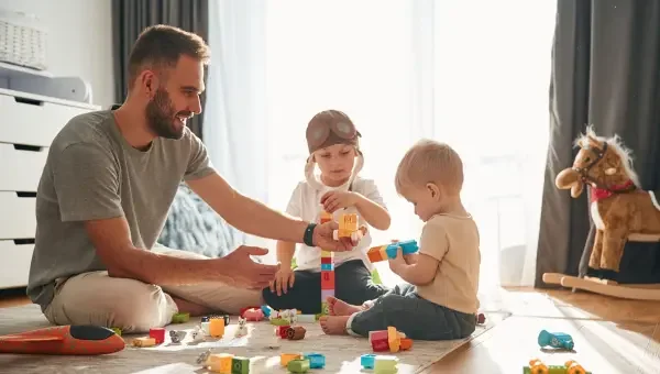 Parent supervising a child playing safely with a toy