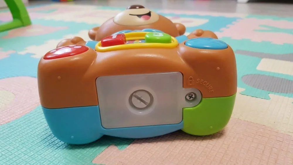 Toy with a secure battery compartment designed for toddlers